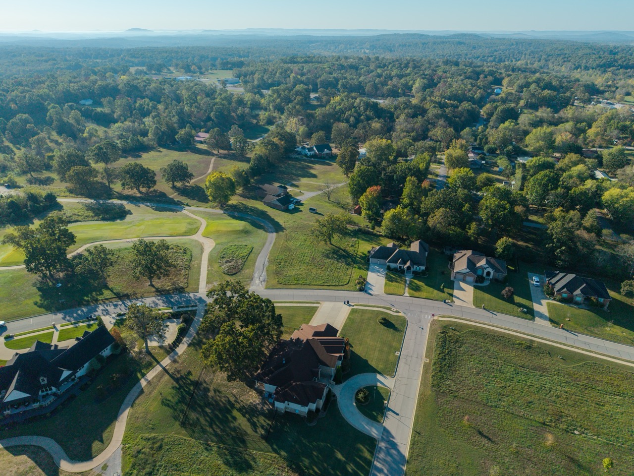 Aerial view of suburban neighborhood with houses and winding roads