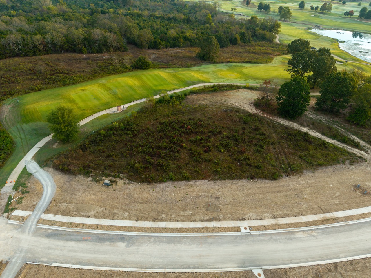 Aerial view of golf course fairway and cart path.