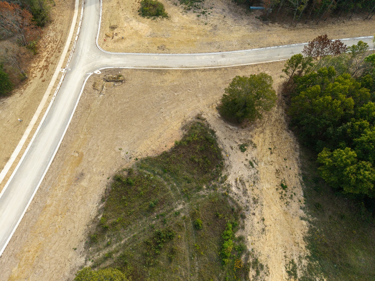 Aerial view of curved road intersection over barren terrain