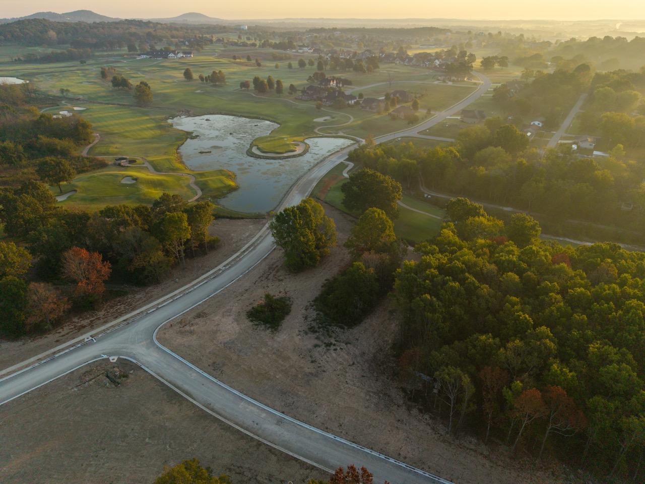 golf course with winding road and ponds