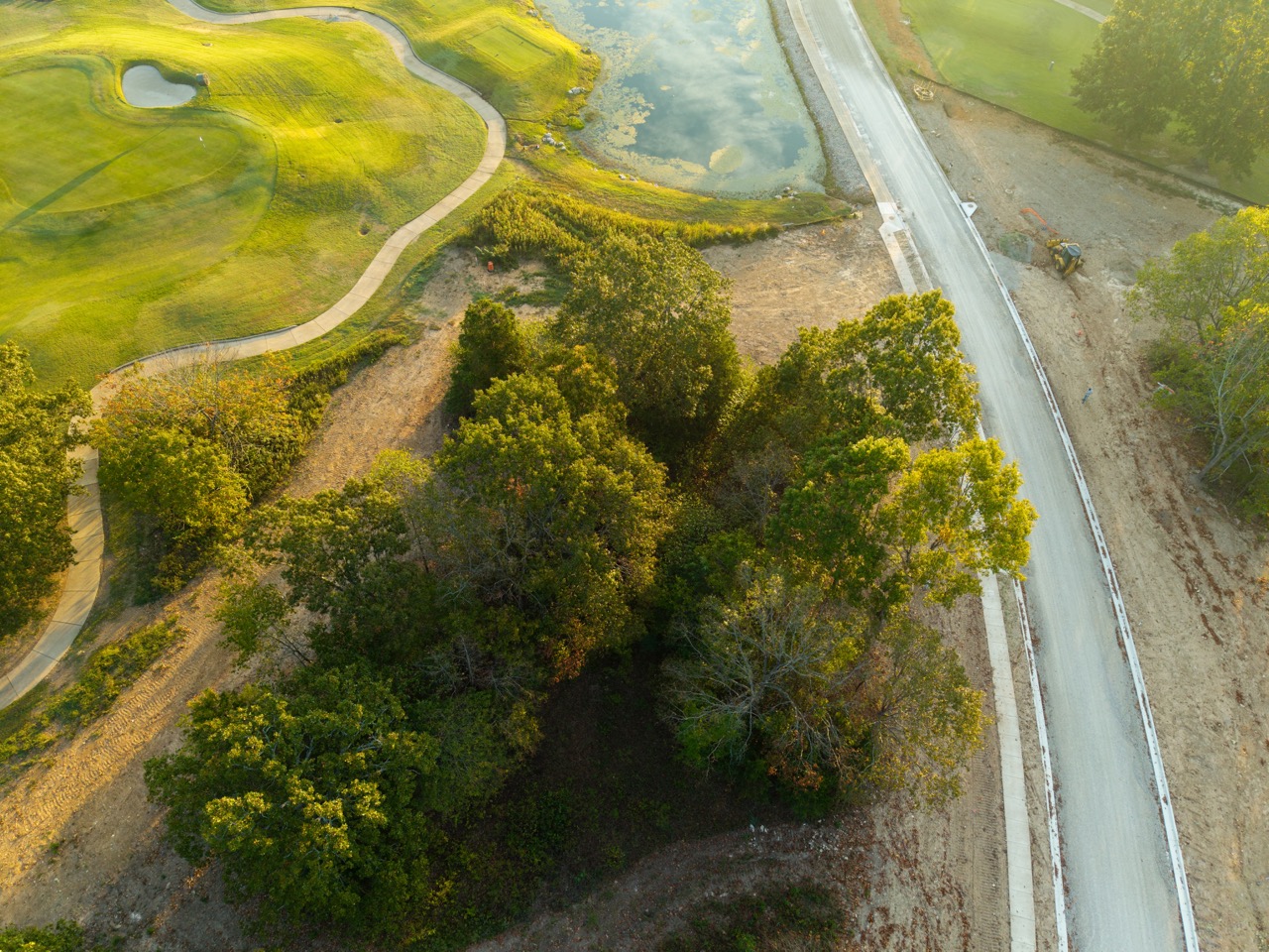 Aerial view of winding golf course and pond