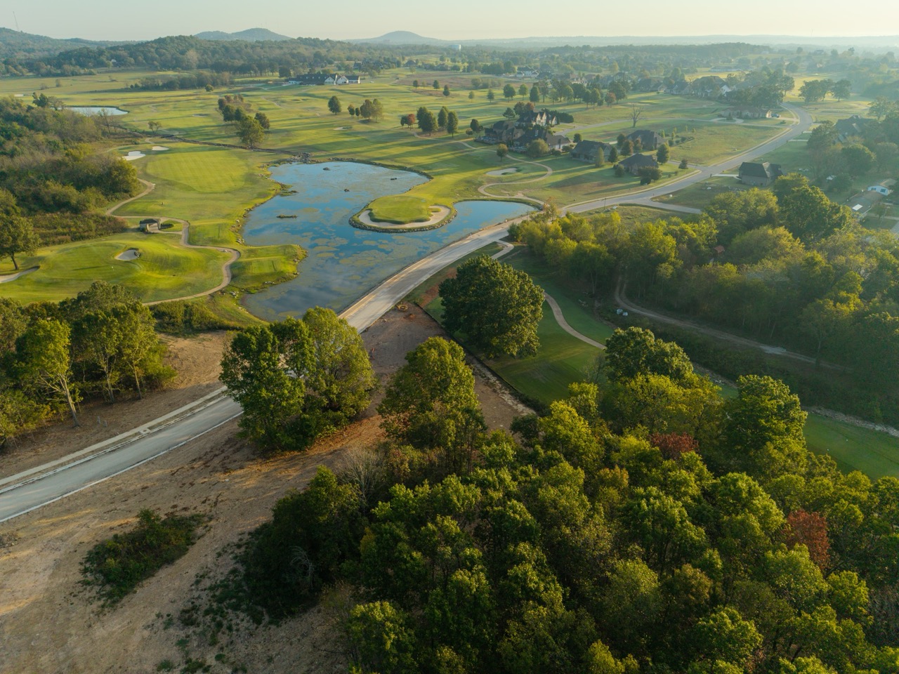 Aerial view of golf course with ponds and trees
