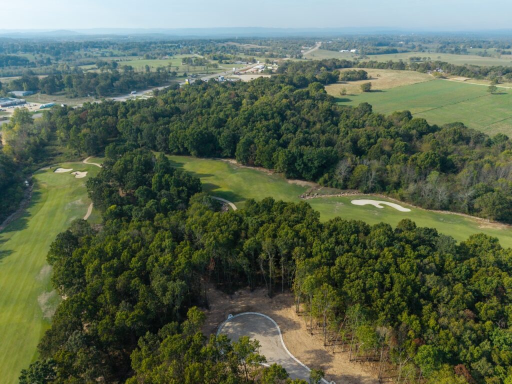 Aerial view of a golf course with sand bunkers.