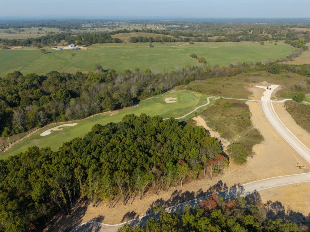 Aerial view of a golf course with greens and sand bunkers.