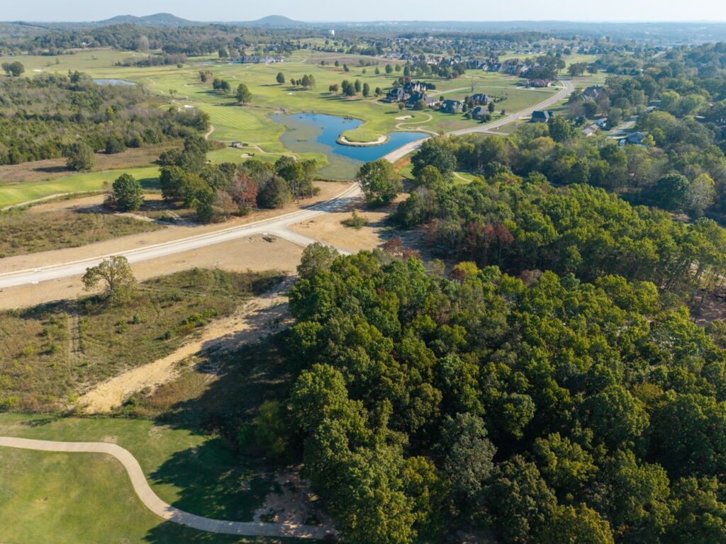 Golf course with ponds, greens, and surrounding trees
