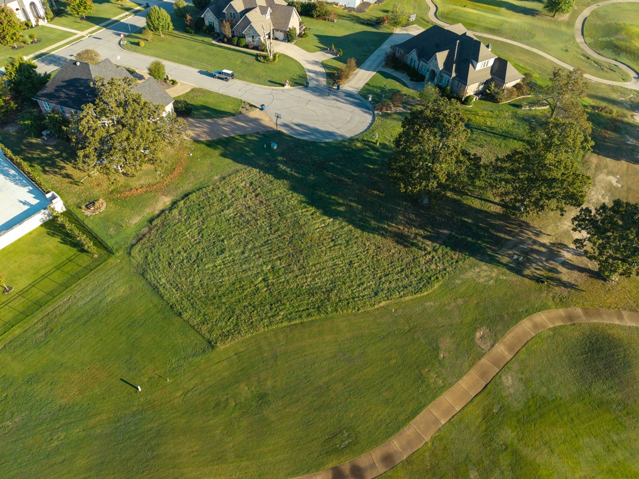 Aerial view of suburban cul-de-sac with surrounding houses.