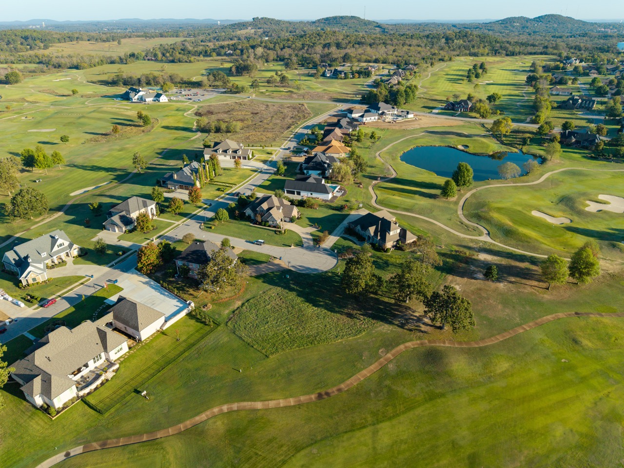 Aerial view of residential neighborhood around a golf course.