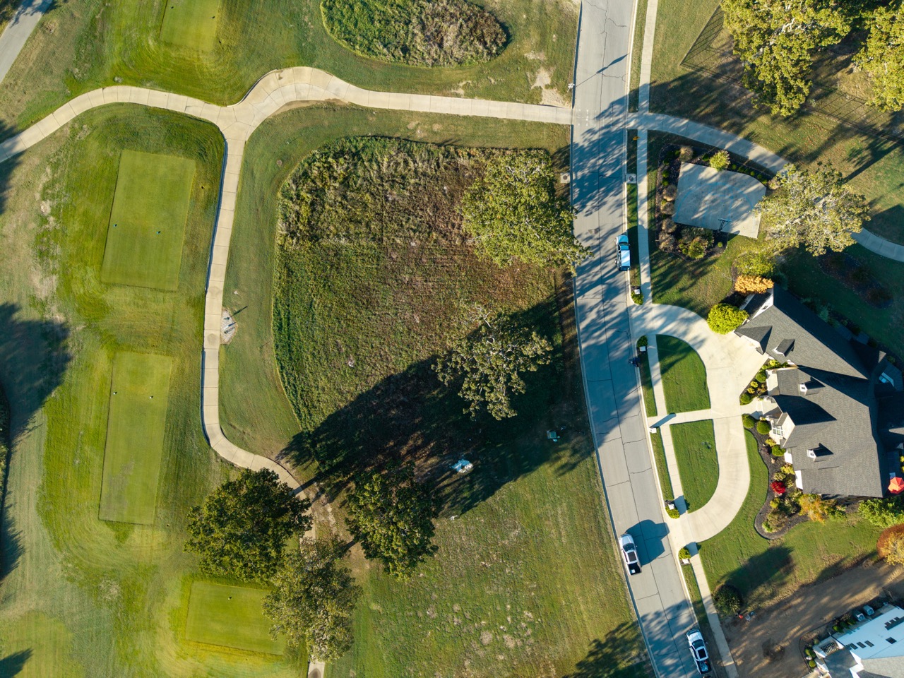 Aerial view of suburban neighborhood with curved sidewalks.