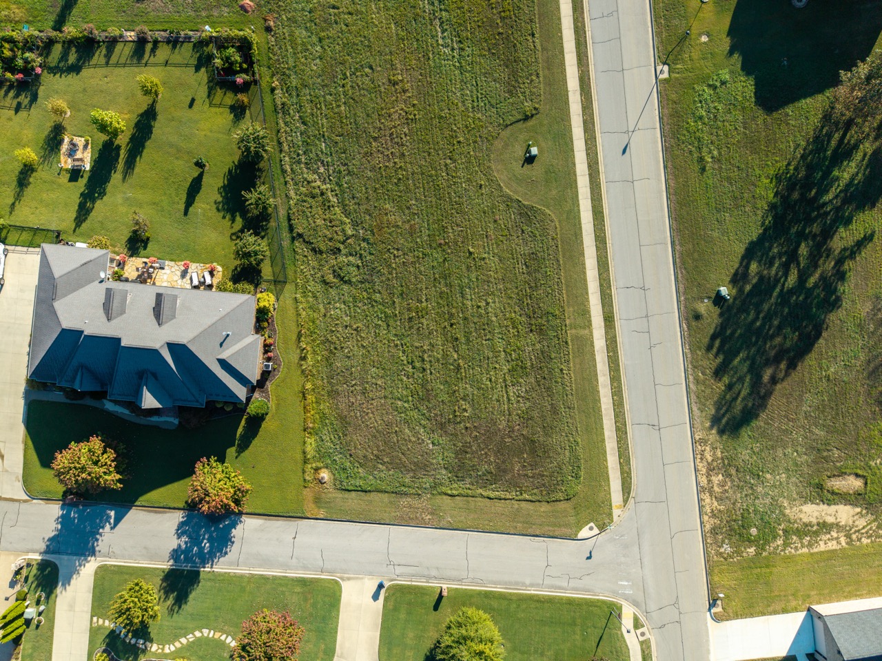 Suburban house with gray roof and green yard