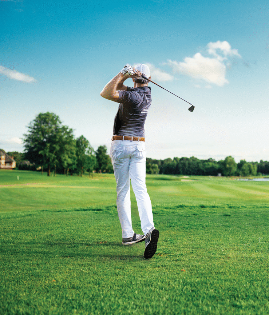 Golfer swinging golf club