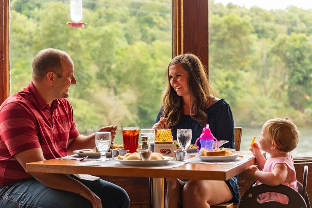 Family of three dining at a restaurant table.